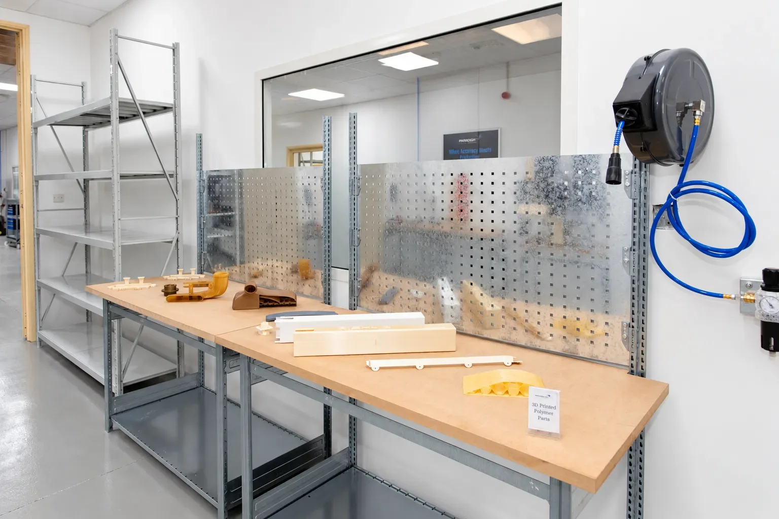 Printed polymer parts laid out on a workshop bench