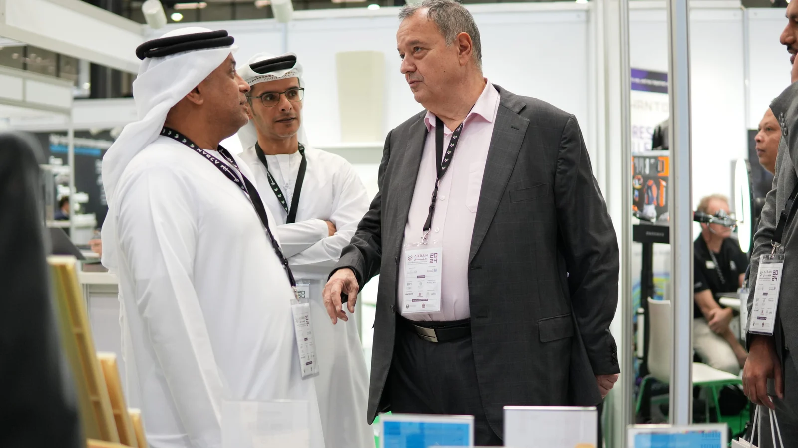 Paradigm 3D representative speaking with visitors at Ajban 2025