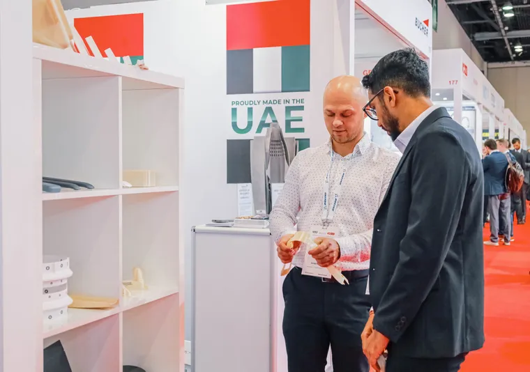 Paradigm 3D engineer showing a printed cabin part to a visitor at MRO Middle East 2025