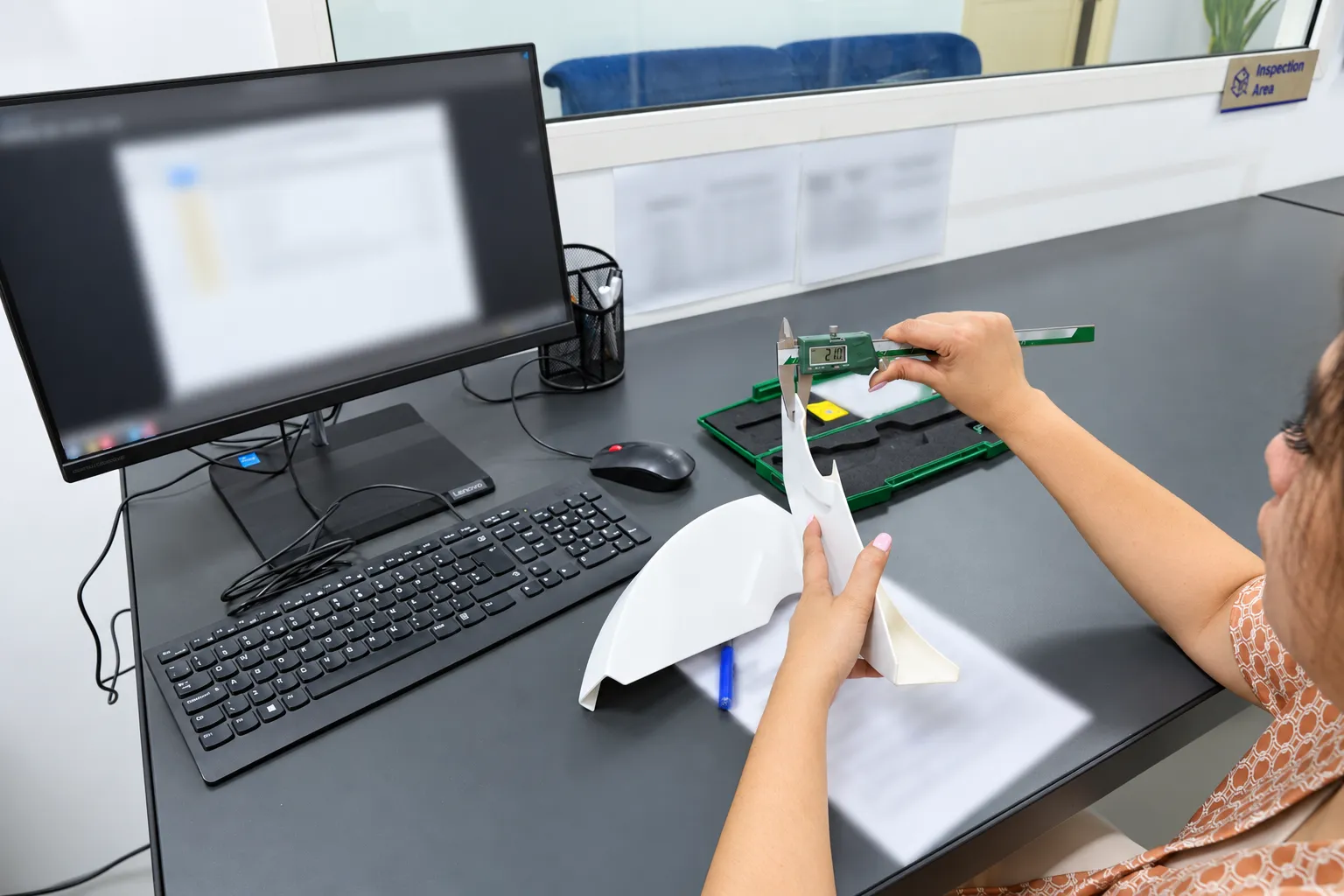 Inspector measuring a printed part