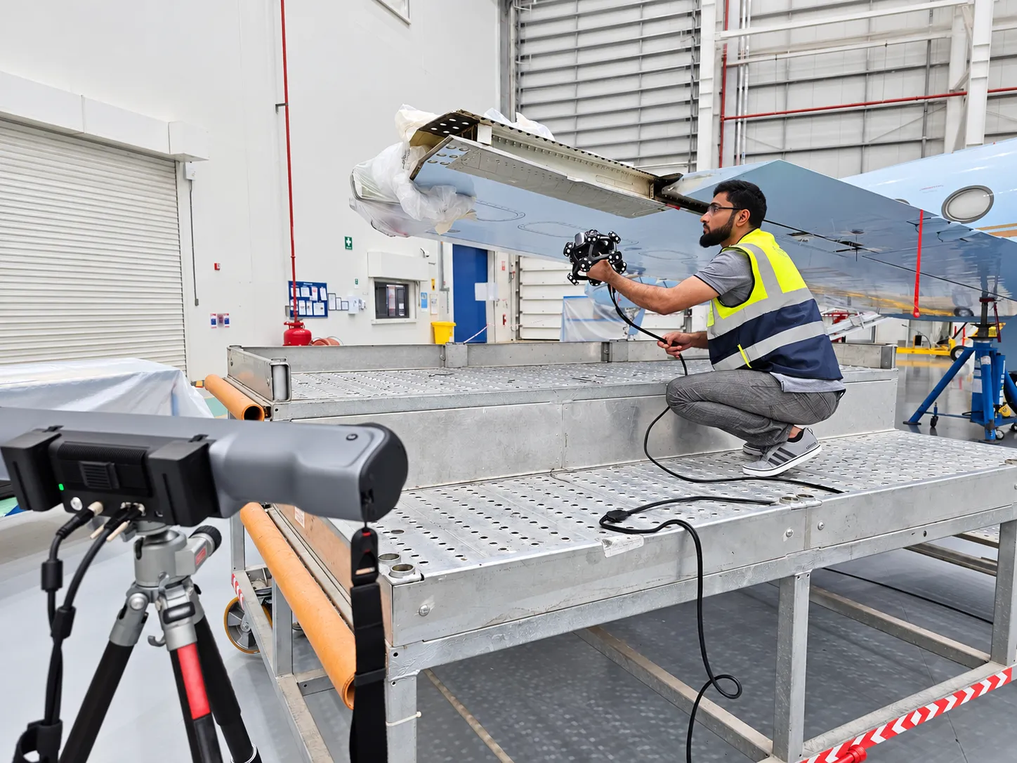 Operator scanning a large component at an aircraft