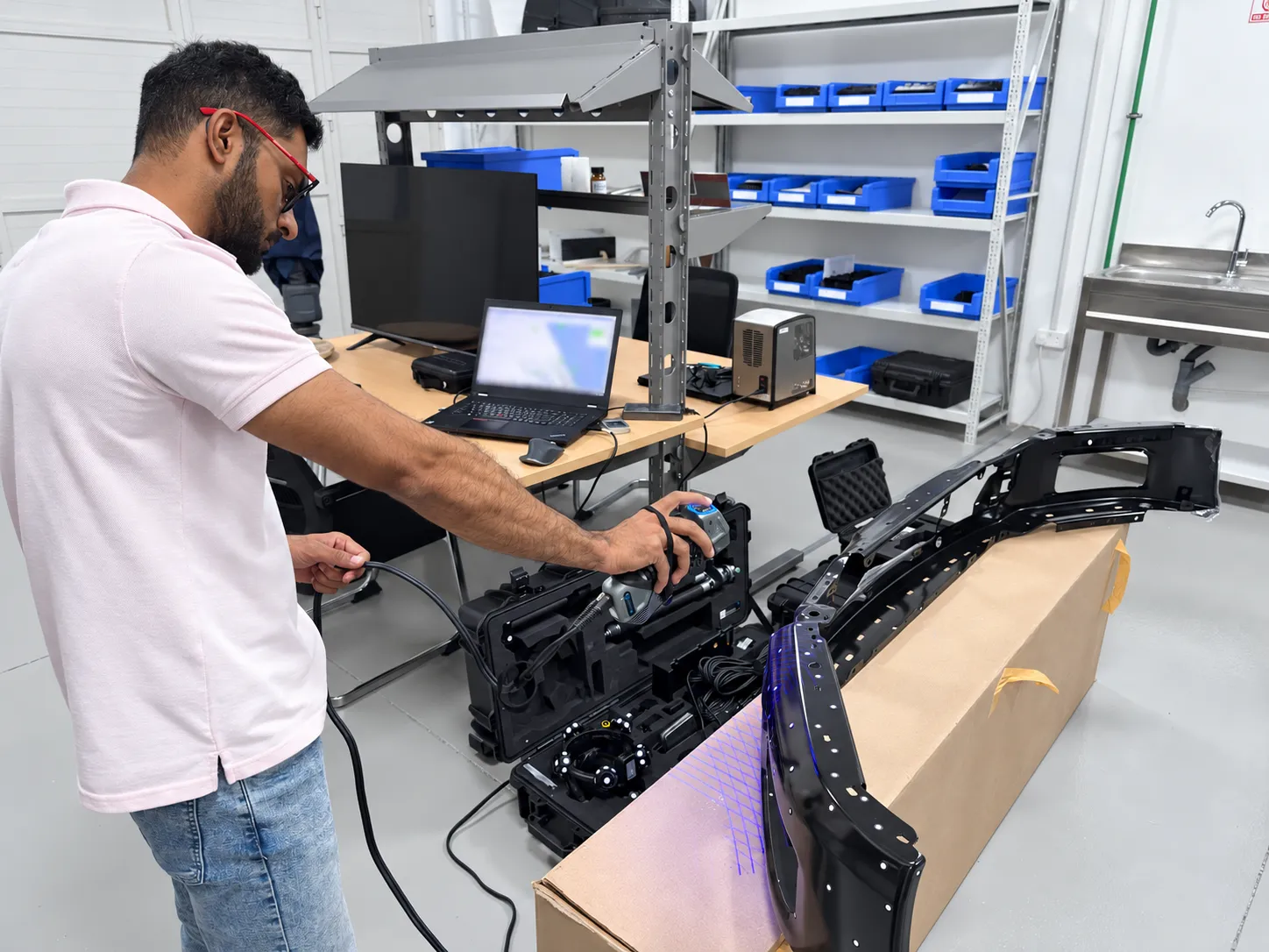Operator scanning an automotive bumper