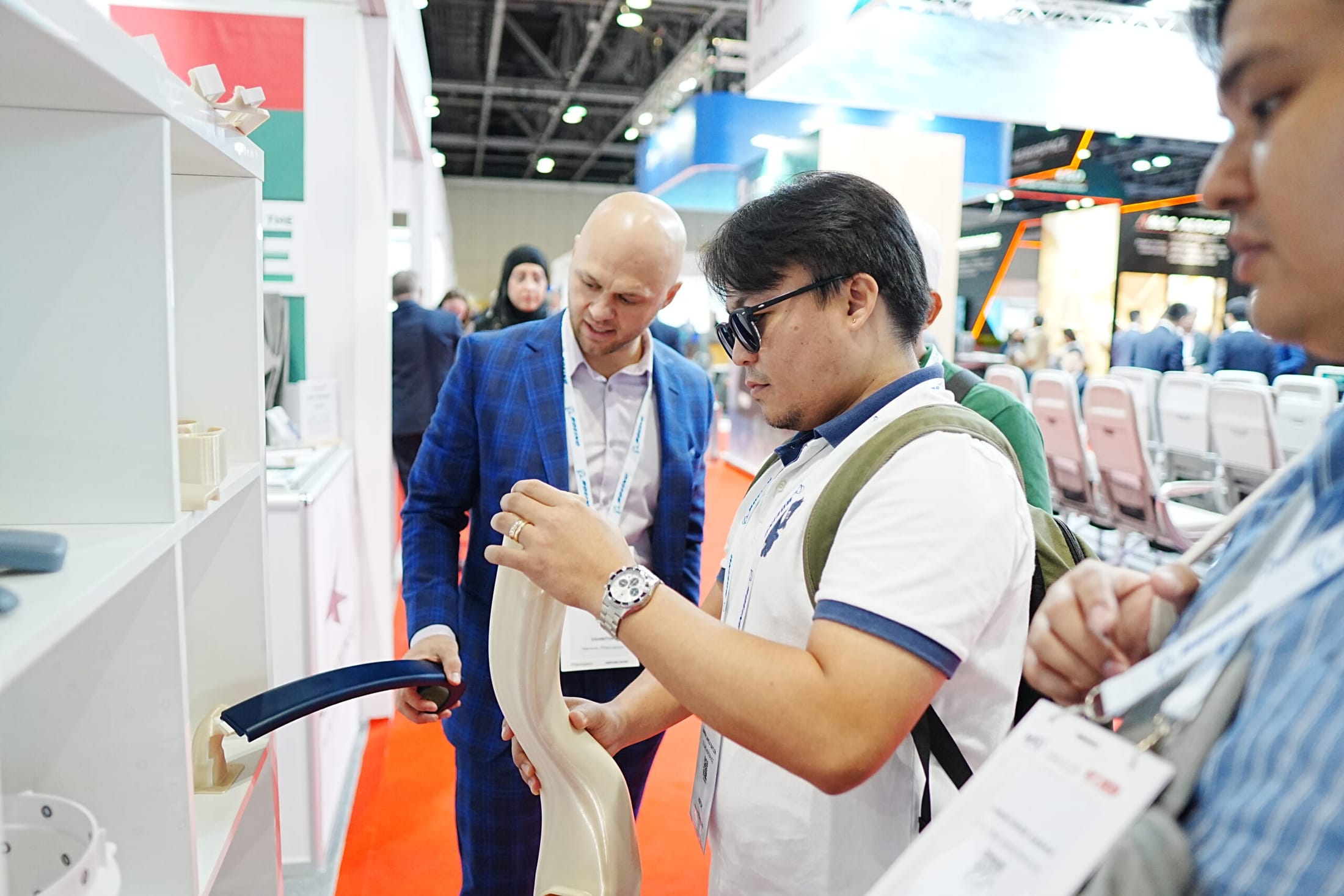 Paradigm 3D engineer showing a printed cabin component to visitors