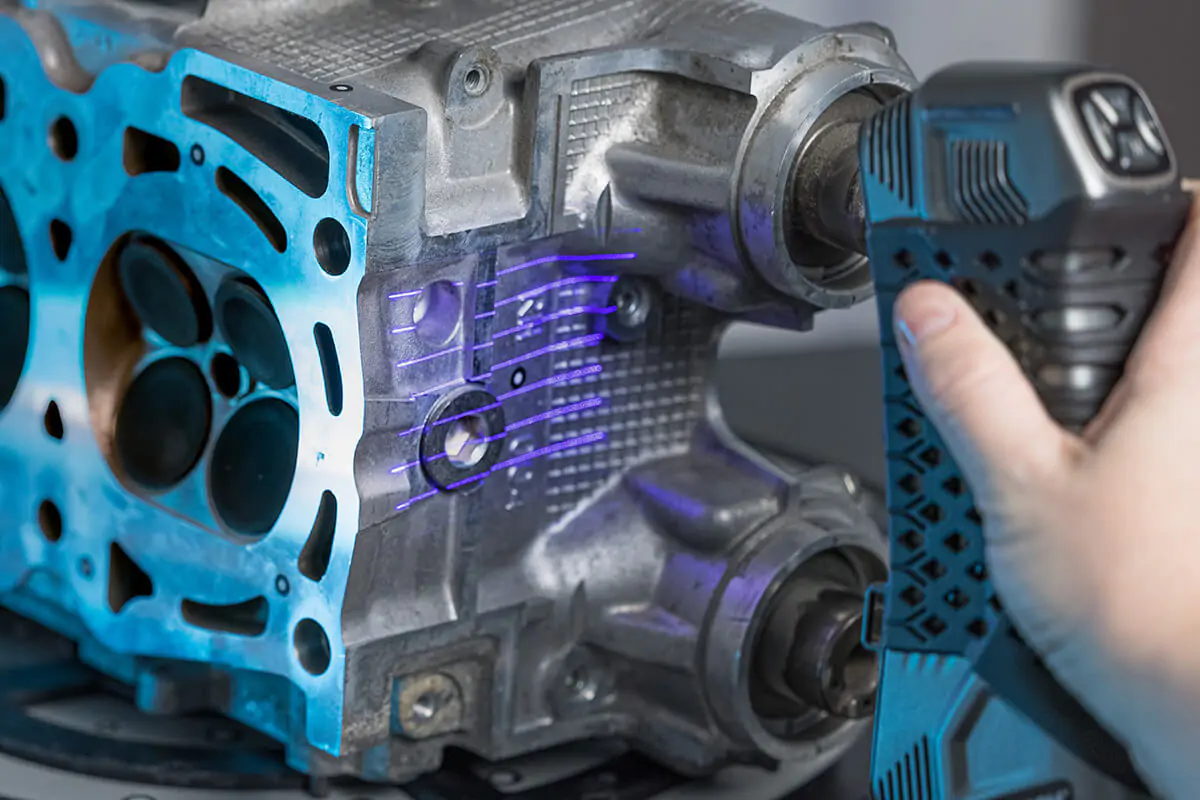 SIMSCAN handheld scanner capturing detailed surfaces of an engine component